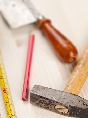 Wooden plank with measurement tape and tools with selective focusの写真素材