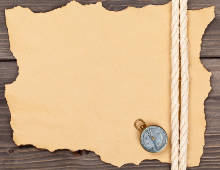 Blank old paper with compass and rope on wooden backgroundの写真素材