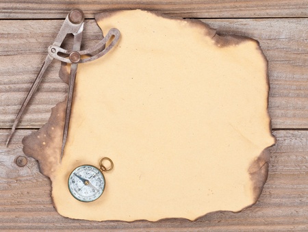Blank old paper with compass and compass on wooden backgroundの写真素材