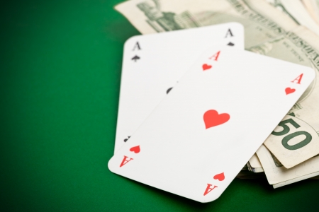 Pocket aces on dollar bills on poker tableの写真素材