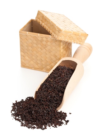 Ceylon black tea crop in wooden scoop over white backgroundの写真素材