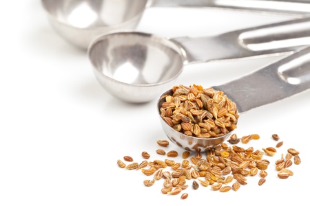 Anise seed in metal scoop over white backgroundの写真素材