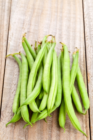 Heap of organic pole beans on wooden tableの写真素材