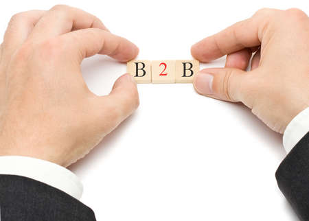 Hands putting the letters for B2B - business to business - togetherの写真素材