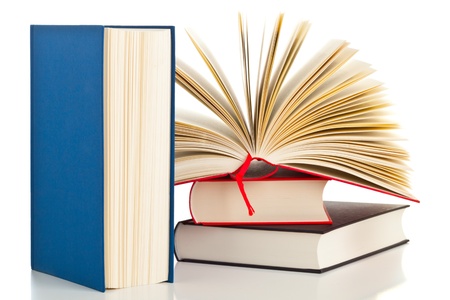 Multiple books with one opened isolated on white backgroundの写真素材