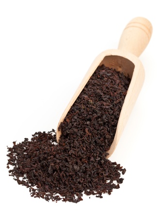 Ceylon black tea crop in wooden scoop over white backgroundの写真素材