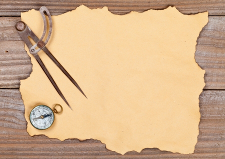 Blank old paper with compass and compass on wooden backgroundの写真素材