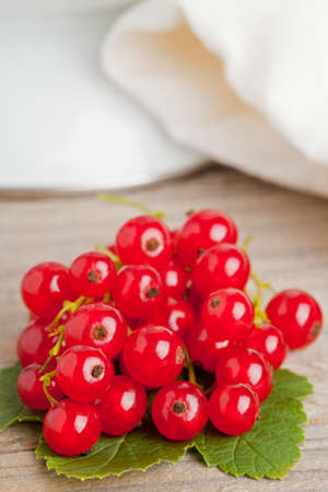 Fresh organic red currants on wooden table