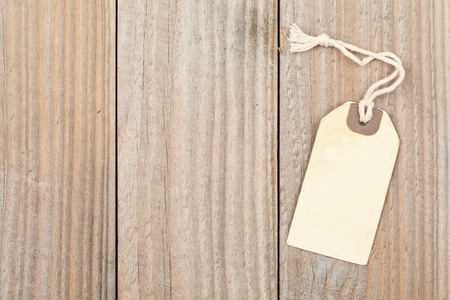 Brown paper vintage label with cord on wooden background