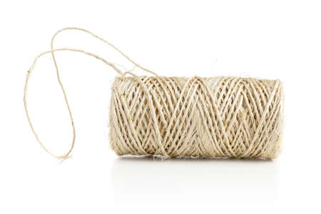 Beige jute or hemp packthread on roll over white background