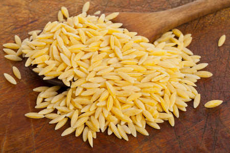 Durum wheat, also hard wheat or macaroni wheat, on wooden spoon kitchen boardの写真素材