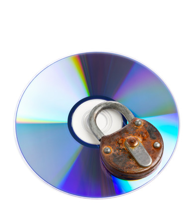 Old rusty locked padlock on data disc isolated on white background - information or data security conceptの写真素材