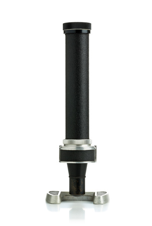 Vintage black and metal microscope front view over white background