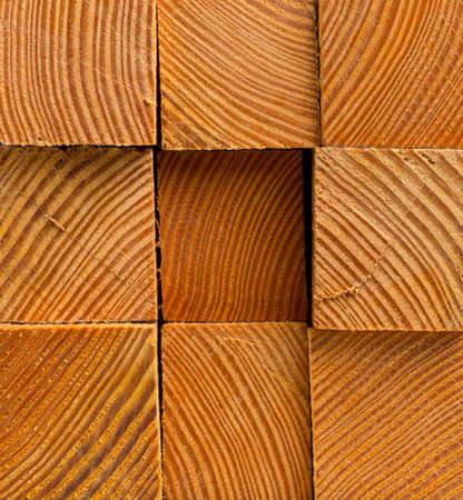 Stacked rough wooden blocks close up background textureの写真素材