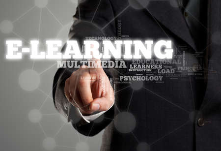 Businessman touching e-learning in wordcloud on transparent surface display