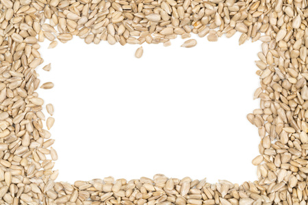 Natural shelled sunflower seeds frame over white backgroundの写真素材