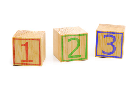 Three brown wooden cubes lined up in a row with numbers one, two and three over white background -...