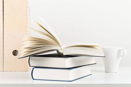 White office desk with books and folders - copy space - study or workplace background mock upの写真素材