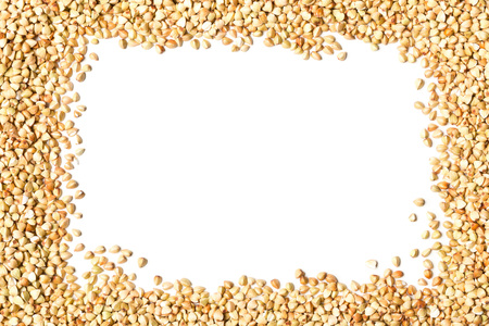 Raw, natural, uncooked buckwheat seed kernels frame over white backgroundの写真素材