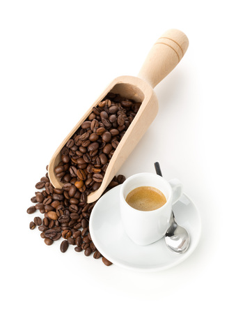 Coffee beans in wooden scoop and cup of espresso on white backgroundの写真素材