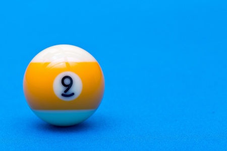 Billiard pool game nine ball on billiard table with blue cloth, copy spaceの写真素材