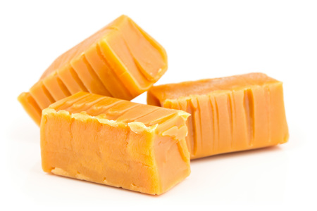 Hand made caramel toffee pieces over white backgroundの写真素材