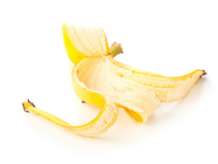 Yellow banana skin over white backgroundの写真素材
