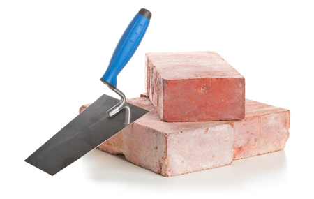 Trowel with bricks isolated on a white background - Home construction or renovation conceptの写真素材