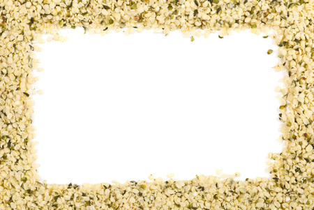Frame of raw, organic hemp seeds over white background with copy spaceの写真素材