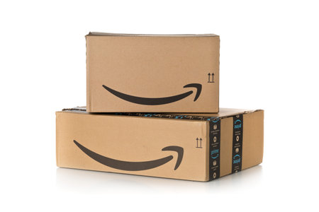 DRESDEN, GERMANY - APRIL 3, 2019 : Stack of Amazon Prime parcels over white background. Prime is a service offered by online retailer Amazon for faster delivery of orders.のeditorial素材