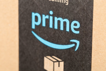 DRESDEN, GERMANY - APRIL 3, 2019 : Close up of Amazon Prime logo on tape of delivered parcel. Prime is a service offered by online retailer Amazon for faster delivery of orders. Selective focus.のeditorial素材