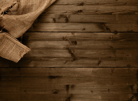 Burlap fabric cloth on brown wooden kitchen table with copy spaceの写真素材