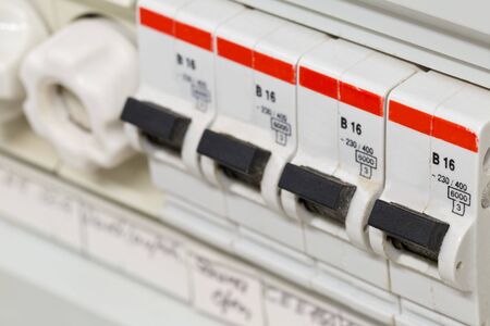 Electric circuit breaker fuse box in private home close up with selective focusの写真素材