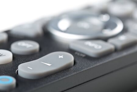 TV remote control close up macro of volume button with selective focus
