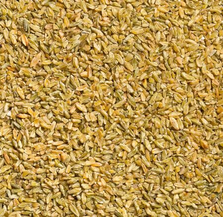Uncooked, raw freekeh or firik, roasted wheat grain, texture background top view flat lay from aboveの写真素材