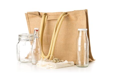 Zero waste or waste free shopping utensils with burlap bag, glass bottles and cotton bag over white background - waste reduction eco lifestyle or bulk buy grocery conceptの写真素材