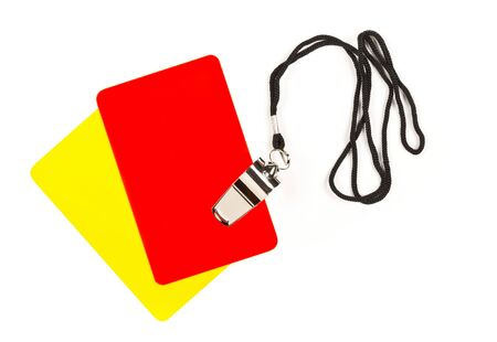 Soccer sports referee yellow and red cards with chrome whistle on white background - penalty, foul or sports conceptの写真素材