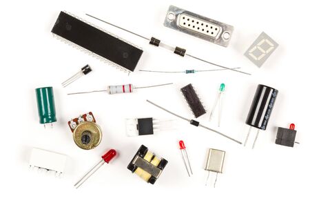 Different electronic parts or components on white background with resistors, capacitors, diode and ic chips, flat lay top view from aboveの写真素材