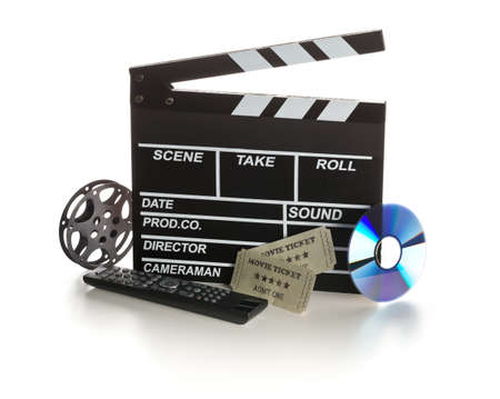 Single, black, open movie clapper or clapper-board with dvd movie disc, film reel, remote control and movie theater tickets on white background - digital movie, home cinema or movie night conceptの写真素材