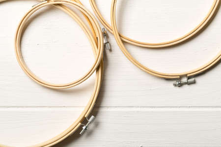 Set of round embroidery or stitching frames on white wooden table background, flat lay top view from aboveの写真素材
