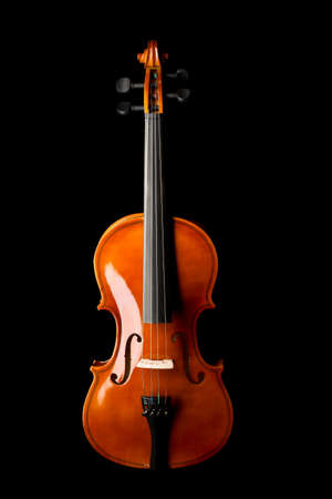 Brown wooden fiddle or violin, classic musical instrument, isolated over black background, flat lay top view from aboveの写真素材
