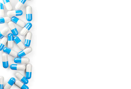 Blue and white pill capsules border edge over white background, medical treatment, pharmaceutical or...