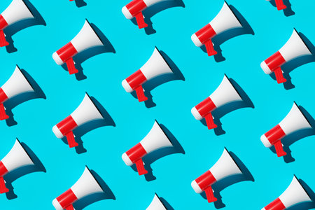 Diagonal array pattern of white and red megaphones or bullhorns over cyan blue background, business announcement or communication concept, flat lay top view from above, 3D illustrationの写真素材