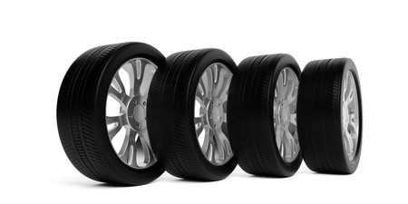 Four car tires with silver rims standing in row on white background, 3D illustrationの写真素材