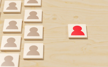 Red person symbol next to group of people symbols on table background, concept of standing out, being different, inclusivity or uniqueness concept, selective focus, 3D illustrationの写真素材