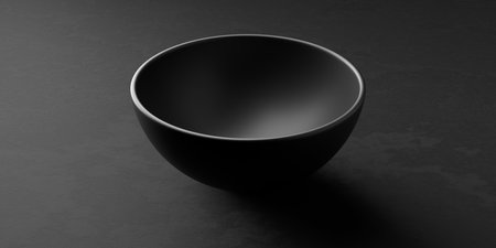 Side view of empty black ceramic bowl or dish on black stone background, 3D illustrationの写真素材