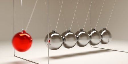 Newton's cradle with moving red ball over brown background, idea, impulse or start-up business...