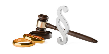 Wooden gavel, judges hammer or mallet with golden wedding rings and paragraph sign on white background, marriage or divorce law, legal or court symbol or concept, 3D illustrationの写真素材