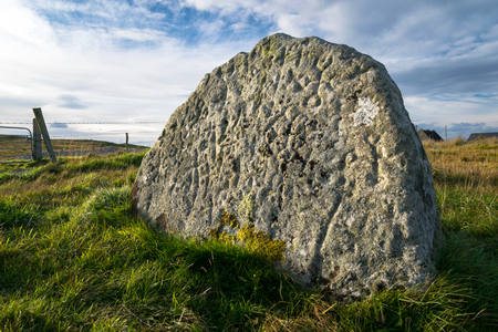This is of a picture of ancient irish rock art carved into a stone in a field in Donegal Ireland.の写真素材