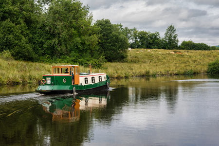Narrow  boat going down a canal in Irelandの写真素材